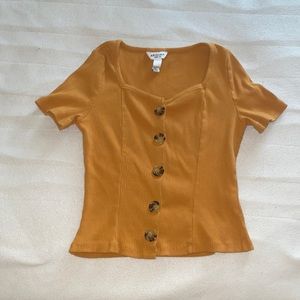 I am selling a dark orange short sleeve shirt it is a size M